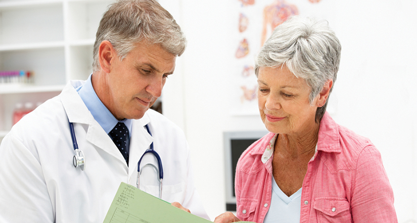 Male doctor discussing results with senior female patient