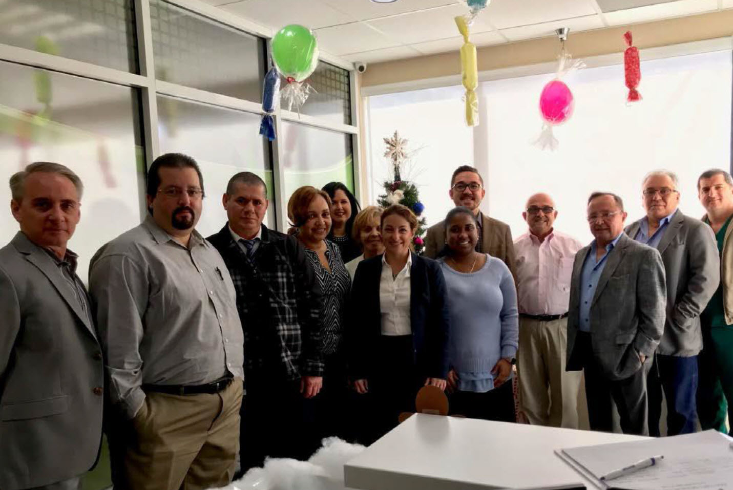 Dr. Portugal smiling and holding up her certificate of completion from the Patient Care Advocacy program.